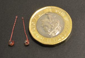 Optical stimulator implant (£1 coin for scale)