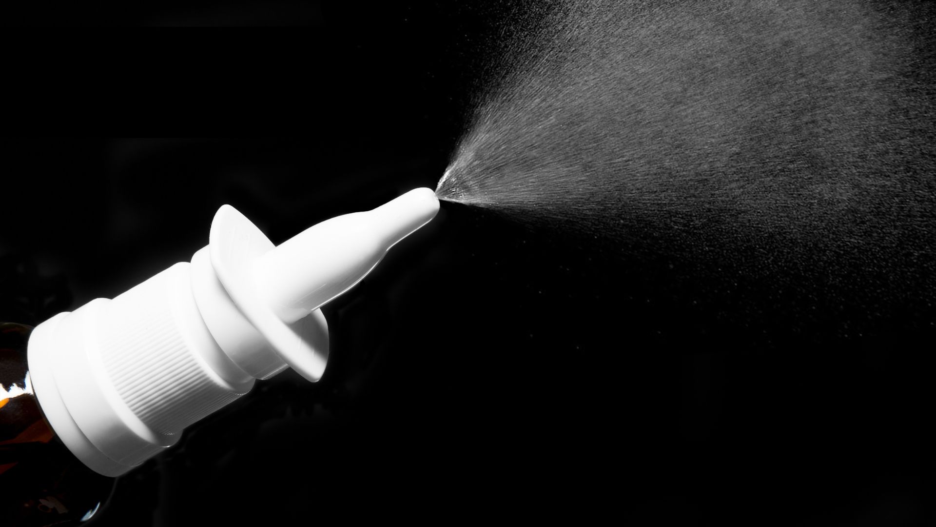 Nasal spray bottle spraying medicine