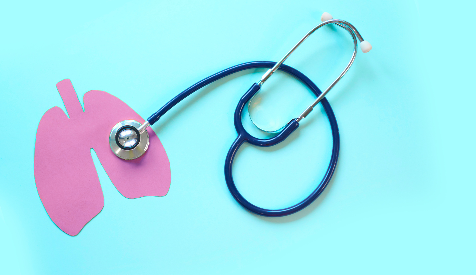 A pair of pink lungs made from paper and a stethoscope