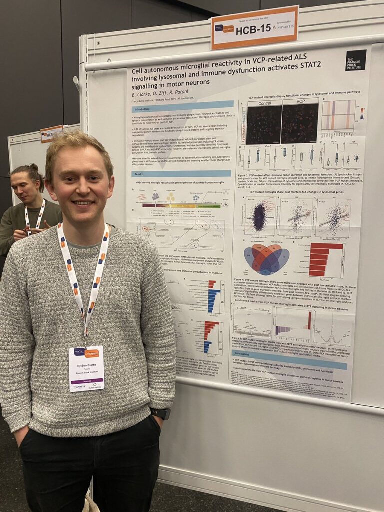 A photo of Ben Clarke standing next to his poster