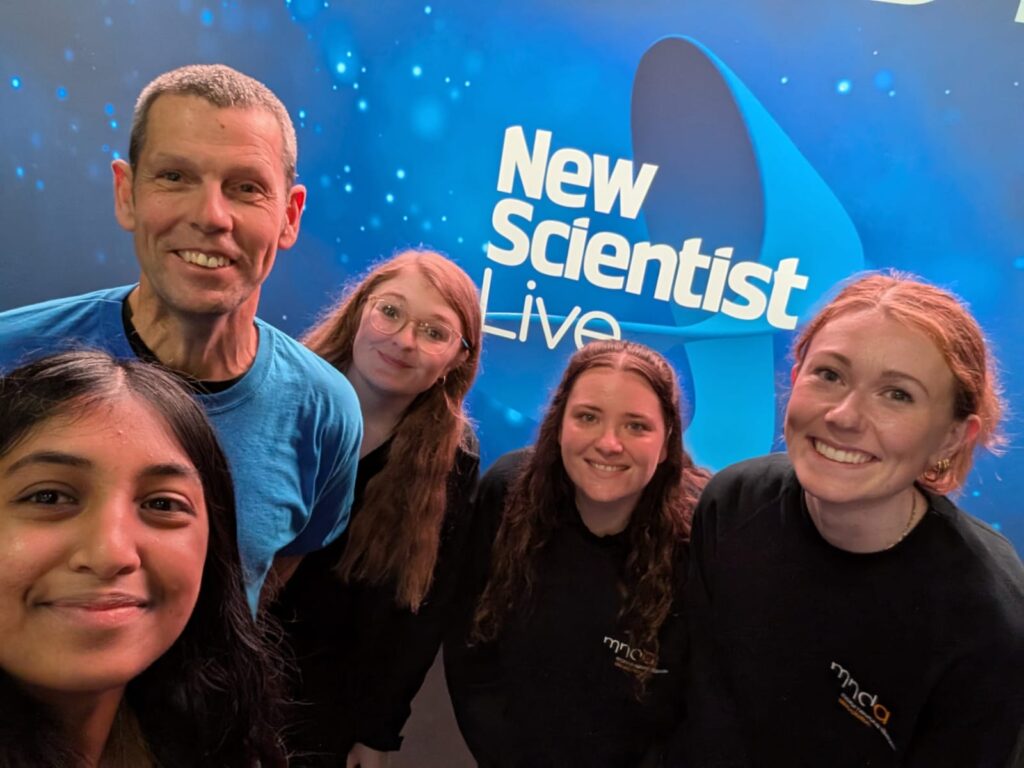 The research team in front if the New Scientist Live logo